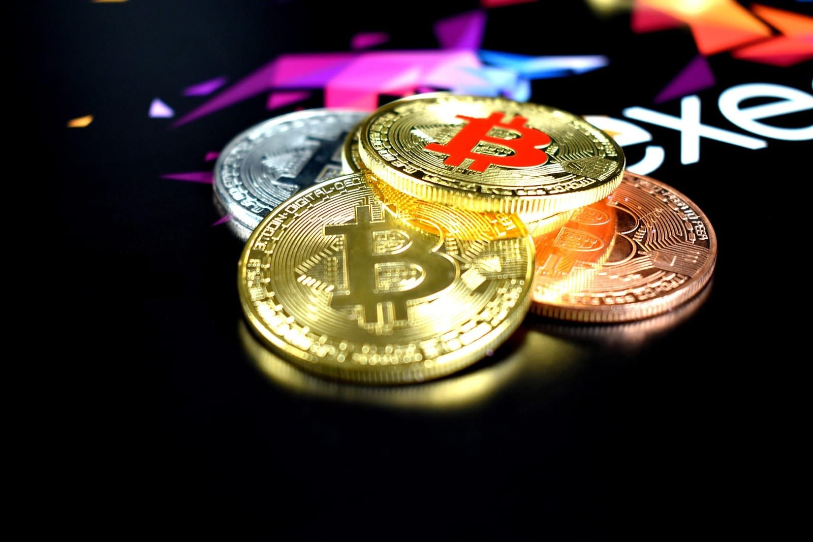 Gold bitcoin coins on a dark background